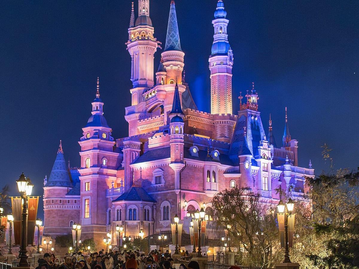 Shanghai Disney castle and fireworks during an evening show.