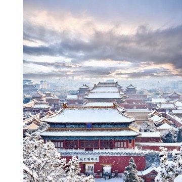Snowy Beijing palace rooftops viewed from Jingshan Park.