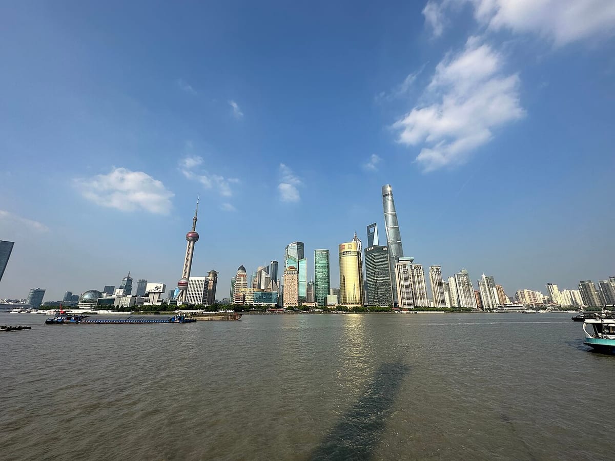 Futuristic Lujiazui skyline and elevated walkways in Shanghai.