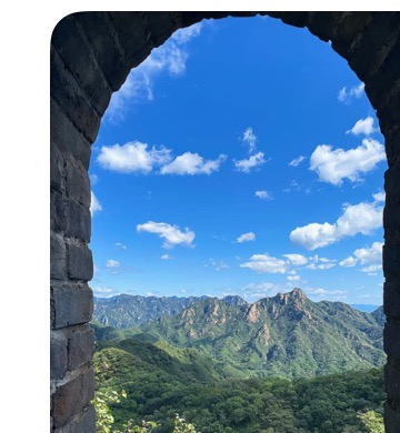 Mountain view through a Great Wall watchtower arch at Mutianyu.