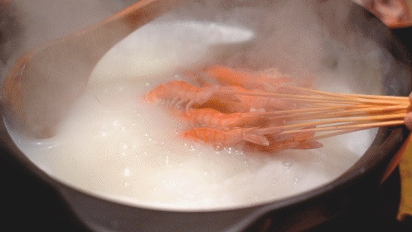 Fresh ingredients cooking in a light Foshan-style hot pot broth.