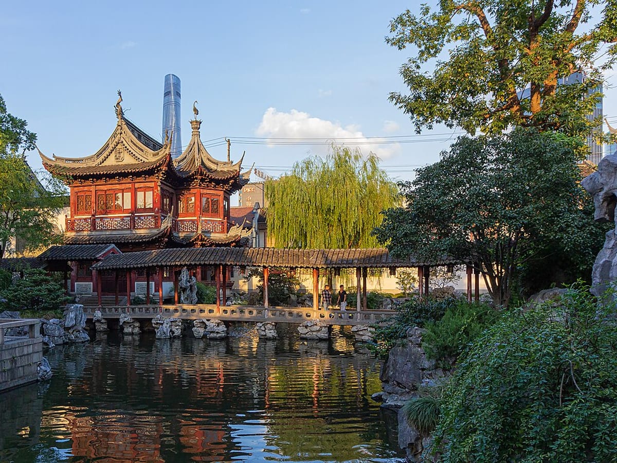Yu Garden old-town buildings and a crowded pedestrian bridge in Shanghai.