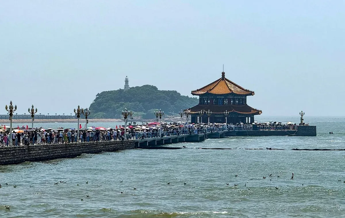 Zhanqiao Pier and Huilan Pavilion extending into Qingdao Bay in daylight